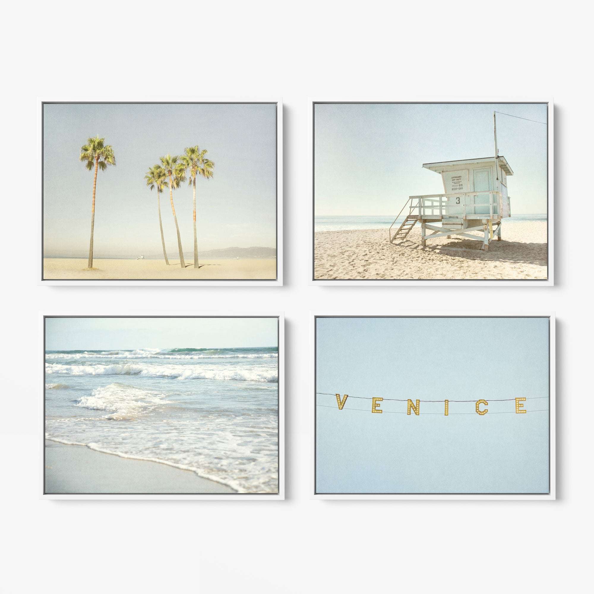 The Offley Green Set of 4 Framed Canvas 24x30 showcases palm trees on sand, a beach lifeguard tower, ocean waves, and lights spelling "VENICE," all in a soft botanical style and muted palette.