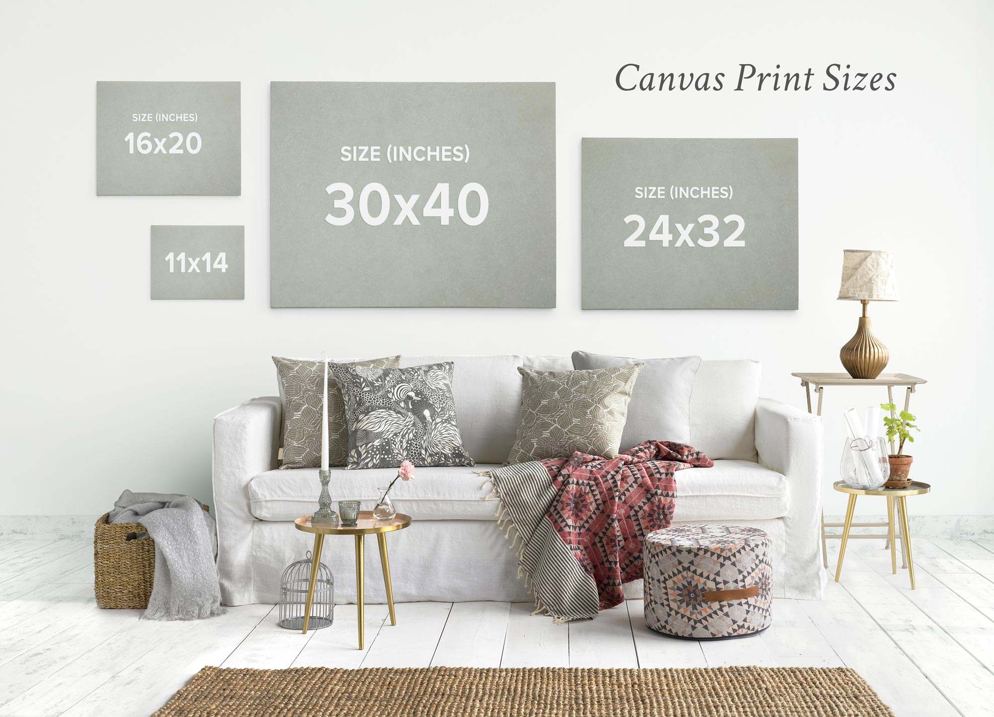 A botanical-style living room features an Offley Green set of 4 framed canvases (24x30) on the wall, a white sofa with patterned cushions, a renewable forest throw blanket, two side tables, and a decorative ottoman.