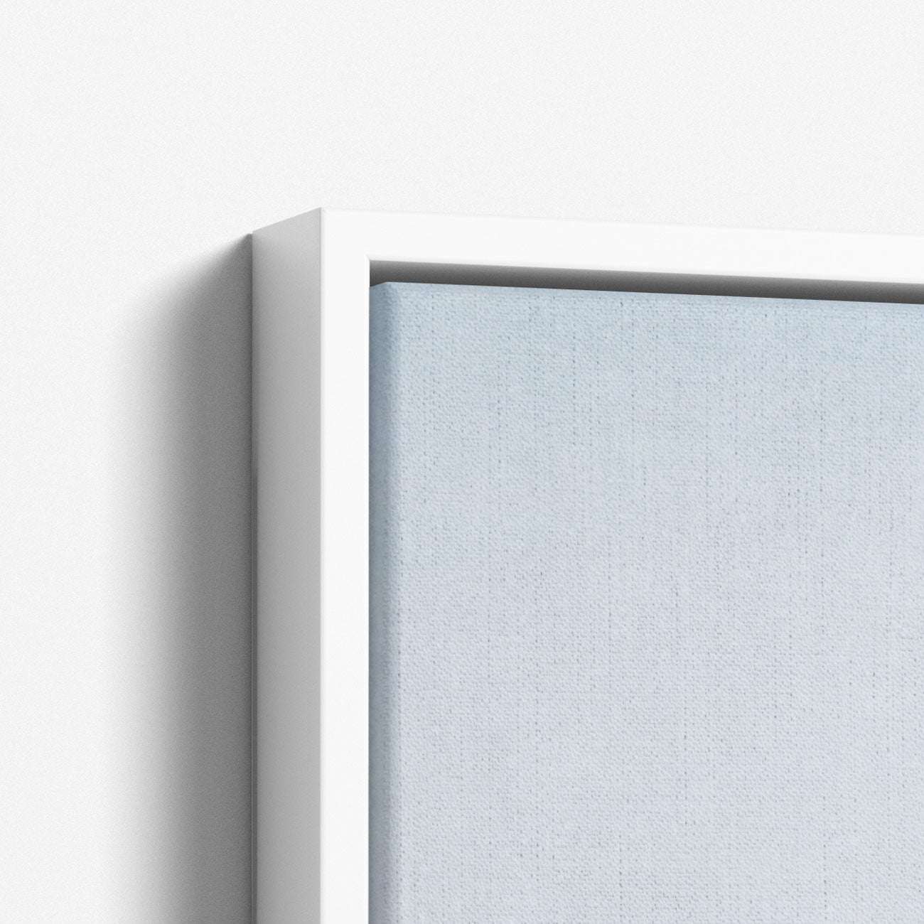 Close-up of a framed canvas print from Offley Green's "Set of 4 Framed Canvas 24x30," showcasing a white frame contrasting with soft blue gradients. Inspired by botanical style, it beautifully highlights the canvas texture and frame simplicity. Choose from multiple combinations.