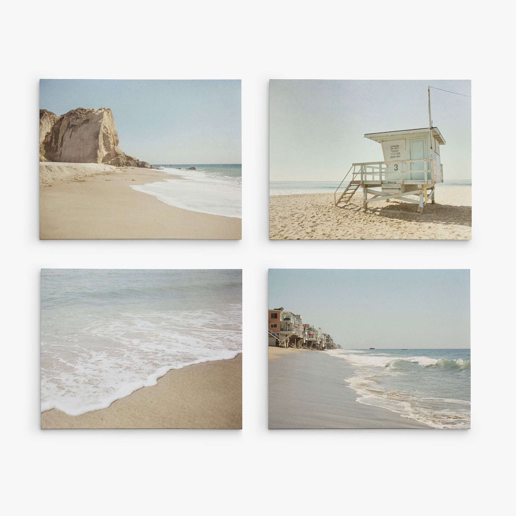 Offley Green's eco-friendly canvas set offers four coastal scenes: sandy cliffs, a lifeguard tower by the shore, gentle waves, and beachside houses. Each piece captures serene views in stunning gallery wraps.