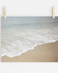 A photograph of a Beach Waves Print, 'Chasing Surf' by Offley Green, printed on archival photographic paper and pinned up by two wooden clothespins on a string against a white background.