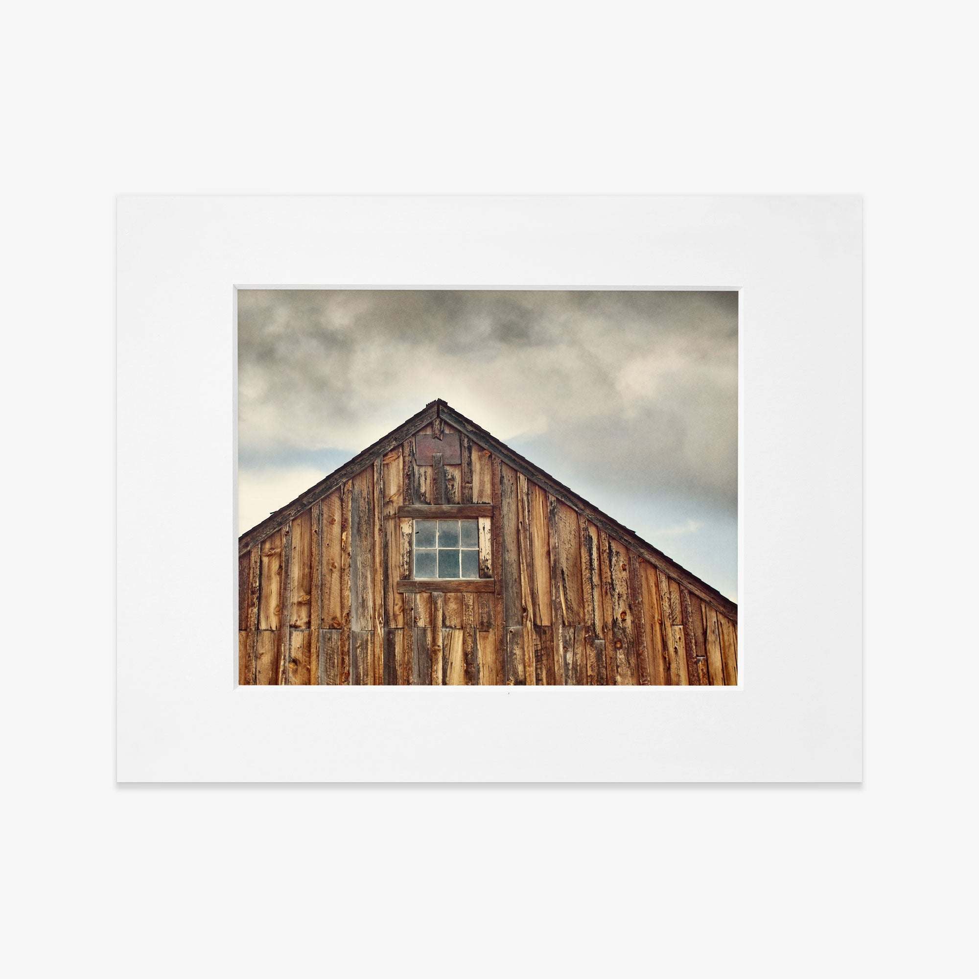 Framed photograph of a Farmhouse Rustic Print, &#39;Old Barn at Bodie&#39; by Offley Green, set against a cloudy sky, printed on archival photographic paper.
