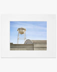 An unframed Los Angeles Sony Pictures Studio Print featuring an aged water tower with the text "rock products" atop a flat-roofed industrial building against a clear sky.