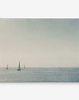 The 16x20 Coastal Canvas Print from Offley Green features a serene, minimalist scene of sailboats on a calm sea with a hazy sky—ideal for canvas gallery wrap. Choose from 10+ designs.