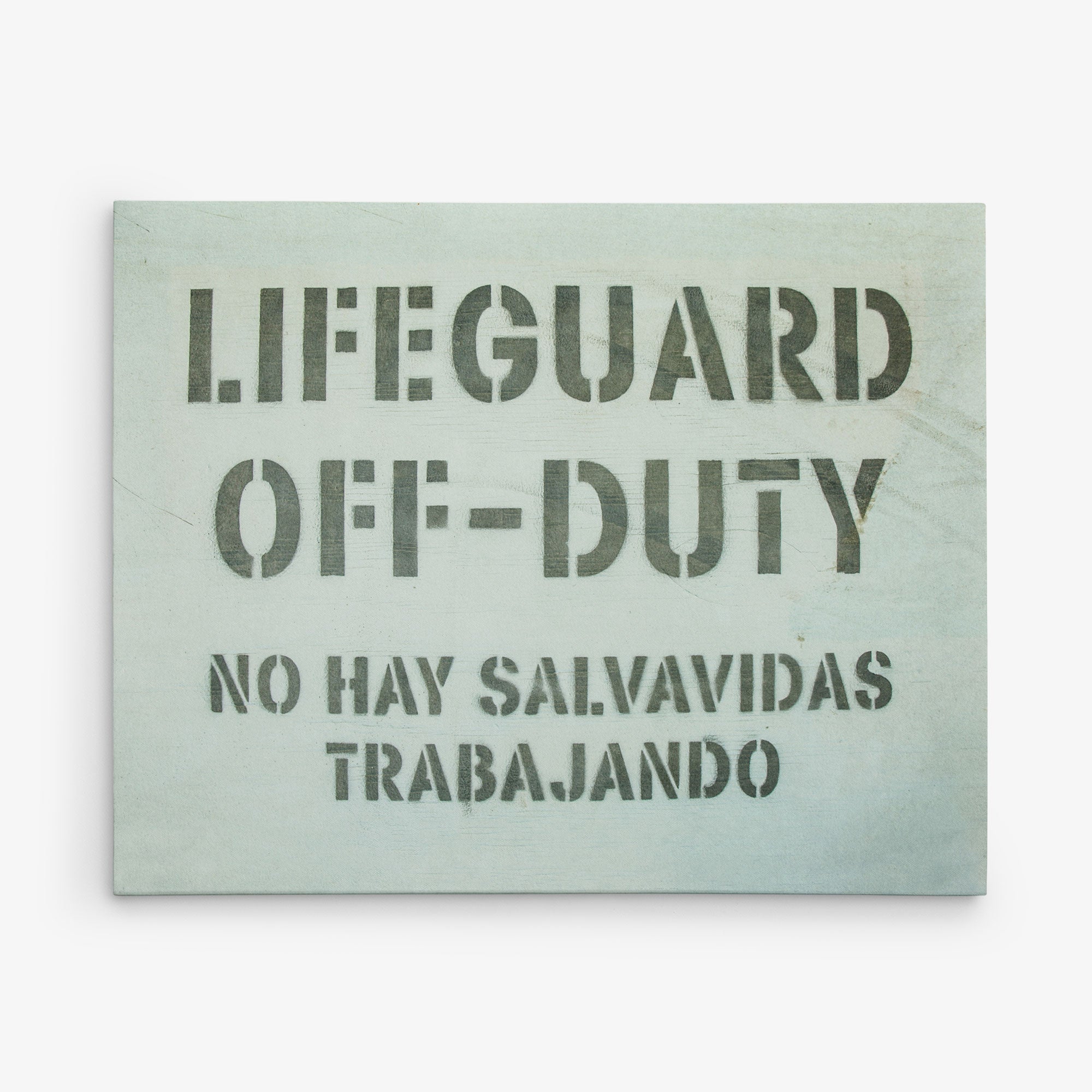 A rectangular sign with a light background contains text in bold black letters. The text reads: "LIFEGUARD OFF-DUTY" and below in Spanish reads: "NO HAY SALVAVIDAS TRABAJANDO." Perfect for **Offley Green**'s **16x20 California Canvas Print (Choose from 10+ Designs)**, this sign indicates that there are no lifeguards on duty.