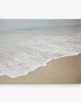 Experience a serene beach scene with Offley Green's 16x20 Coastal Canvas Print. Choose from 10+ designs capturing gentle waves on sandy shores, with calm blue-green waters under a soft, cloudy sky for an exquisite gallery wrap.