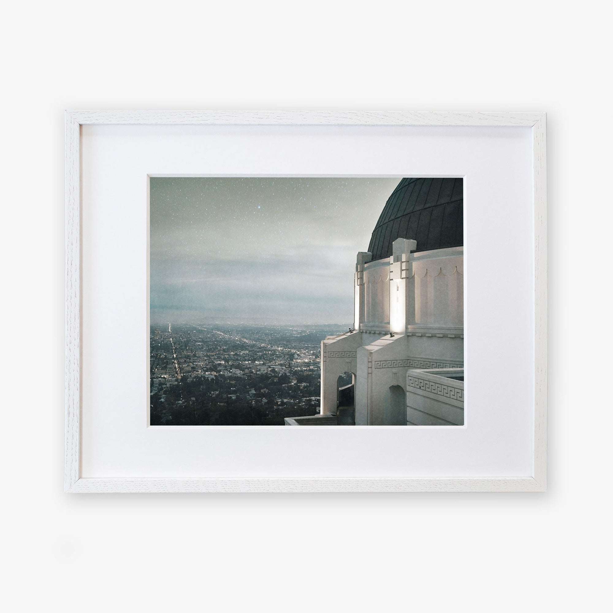 A framed archival photographic Griffith Observatory Print, 'The Sky At Night' of a cityscape viewed from a high vantage point at dusk, featuring the prominent Griffith Observatory with a rounded dome in the foreground against a star-speckled sky by Offley Green.