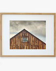 Offley Green's 'Old Barn at Bodie' Farmhouse Rustic Print, emphasizing rustic textures and a single central window, is framed in a simple and light-colored frame printed on archival photographic paper.