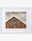 A framed photograph of an Offley Green 'Old Barn at Bodie' farmhouse rustic print, displayed against a white background. The barn has weathered planks and a single small window.
