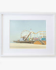 A framed illustration of Santa Monica Pier, featuring a ferris wheel and roller coaster, displayed against a calm blue sky. Get your Offley Green California Print, 'Santa Monica Pier' today!