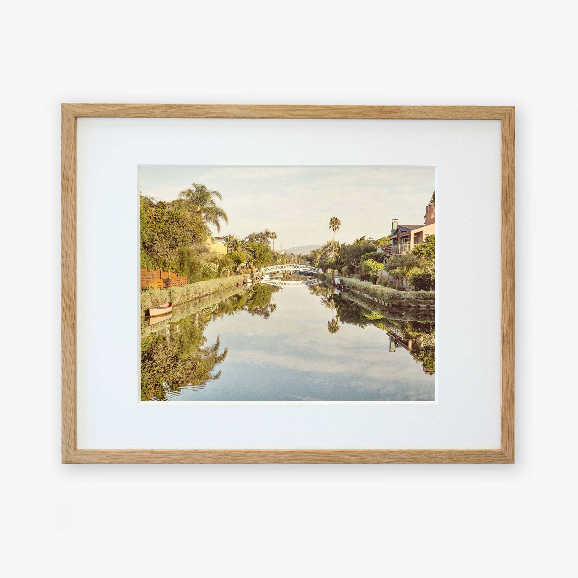 A framed photograph depicting the Venice Beach Canals, printed on archival photographic paper by Offley Green.