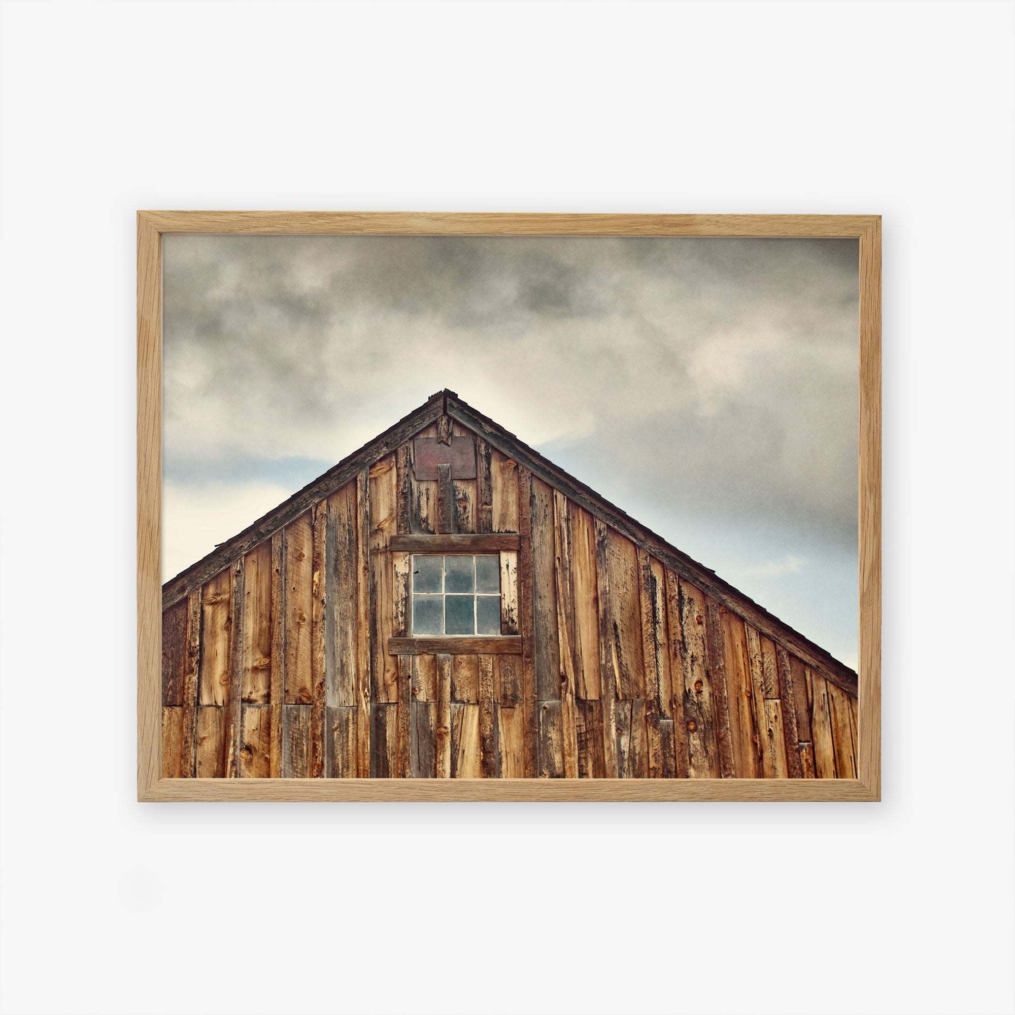 A framed Farmhouse Rustic Print of &#39;Old Barn at Bodie&#39; by Offley Green, showcasing rustic textures and a single centered window, printed on archival photographic paper.