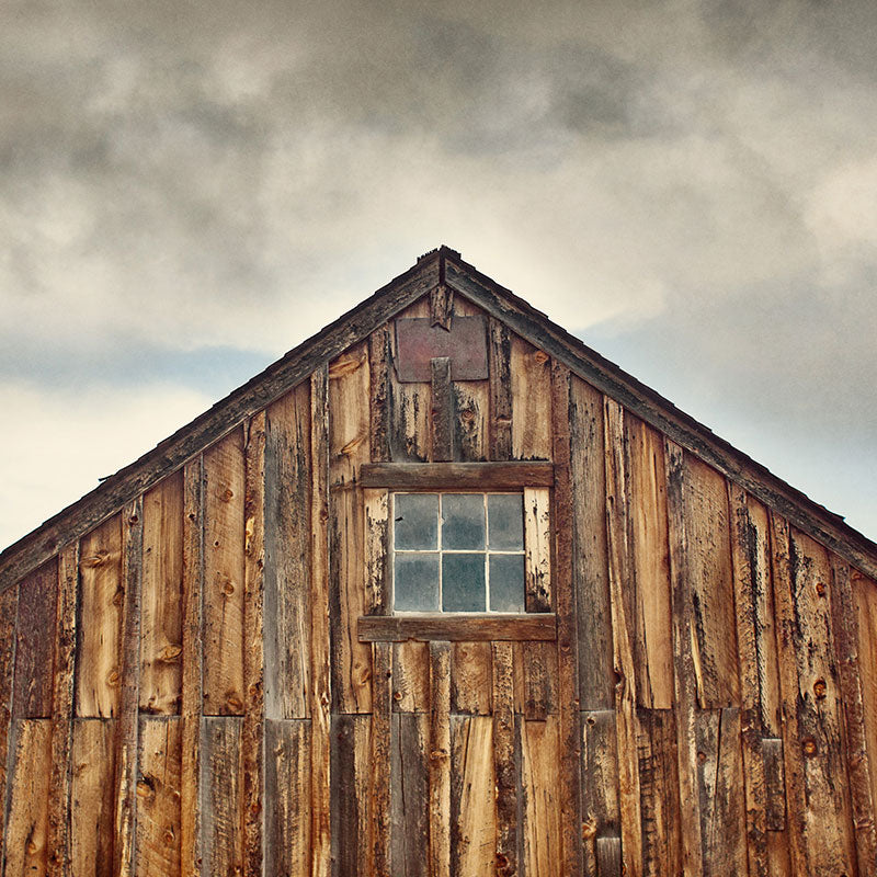 Photographic print of an old rustic barn with rich dark brown wood planks, aged over time.