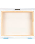 Back view of the Offley Green 8x10 Rustic Canvas Print, featuring a light wooden frame and metal hanger for wall mounting. The rectangular canvas has corners subtly covered with blue and white fabric, ensuring elegance and sourced from FSC certified forests. Choose from 10+ designs.