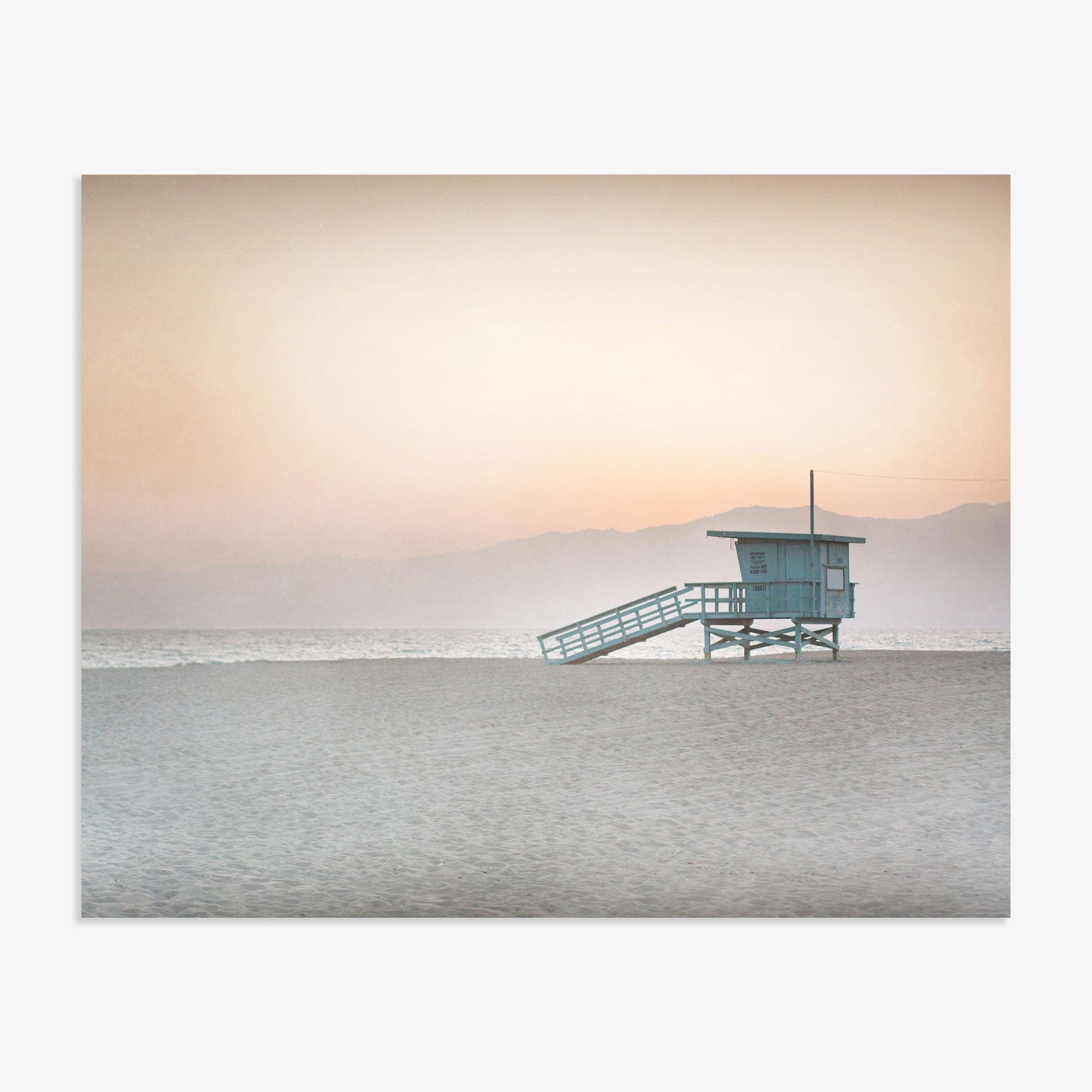 A Pink Coastal Print, &#39;Lifeguard Tower&#39; by Offley Green stands isolated on a sandy beach in Venice with a calm sea in the background under a soft gradient sky of pastel colors at dawn or dusk.