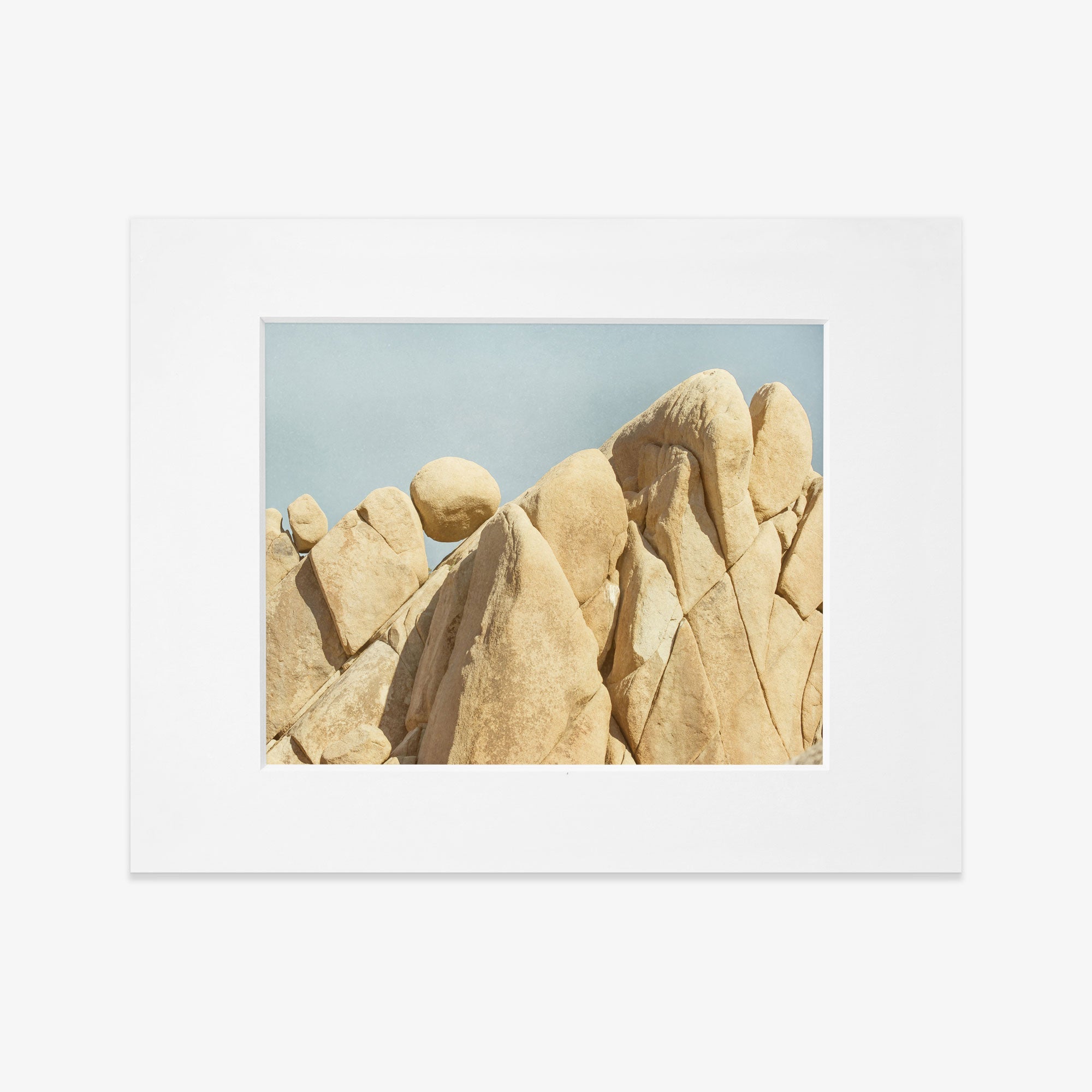 An unframed Joshua Tree Print, &#39;Rock Formations&#39; photograph by Offley Green of unusual, rounded beige rock formations against a clear blue sky. The natural textures and lines on the rocks are distinctly visible.
