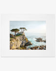 A framed painting of a California Coastal Print, 'Lone Cypress' by Offley Green, featuring trees on a rocky cliff overlooking a turbulent sea at Pebble Beach, displayed against a white background.