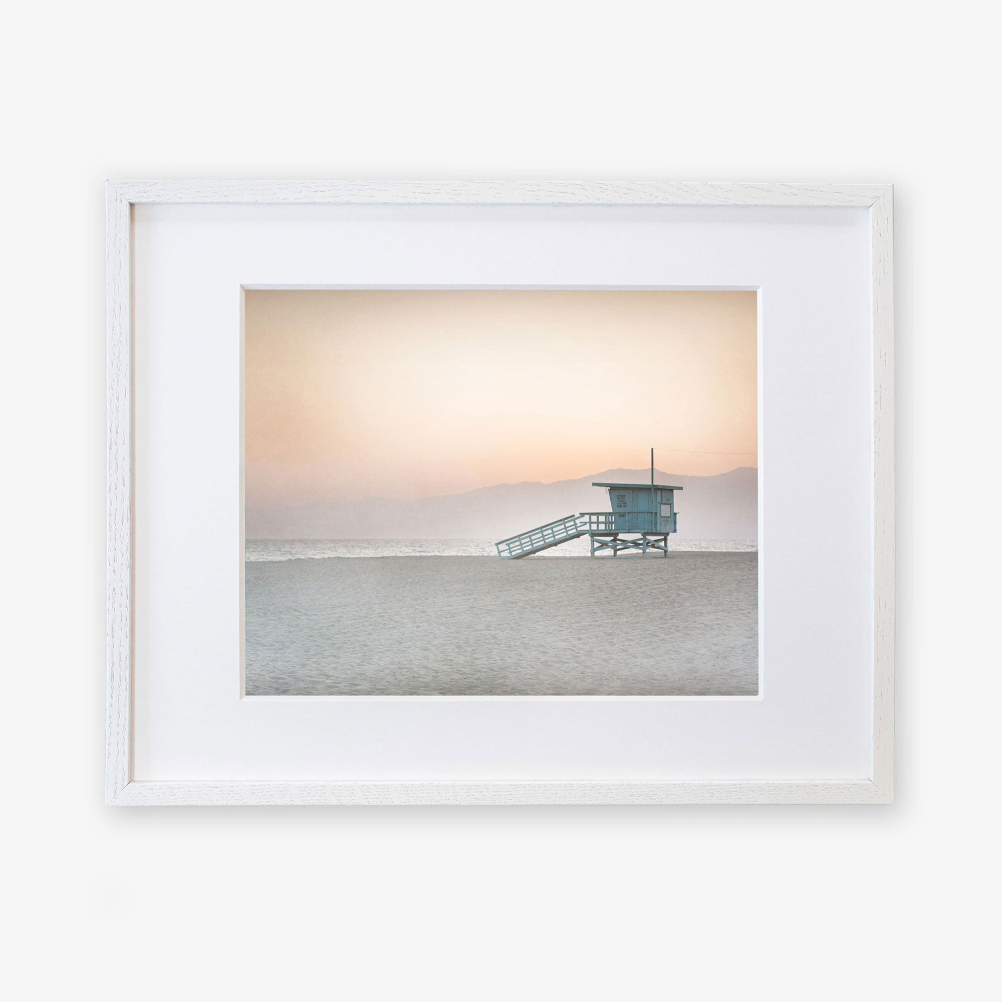A framed photograph of a Pink Coastal Print, 'Lifeguard Tower' by Offley Green, on archival photographic paper.