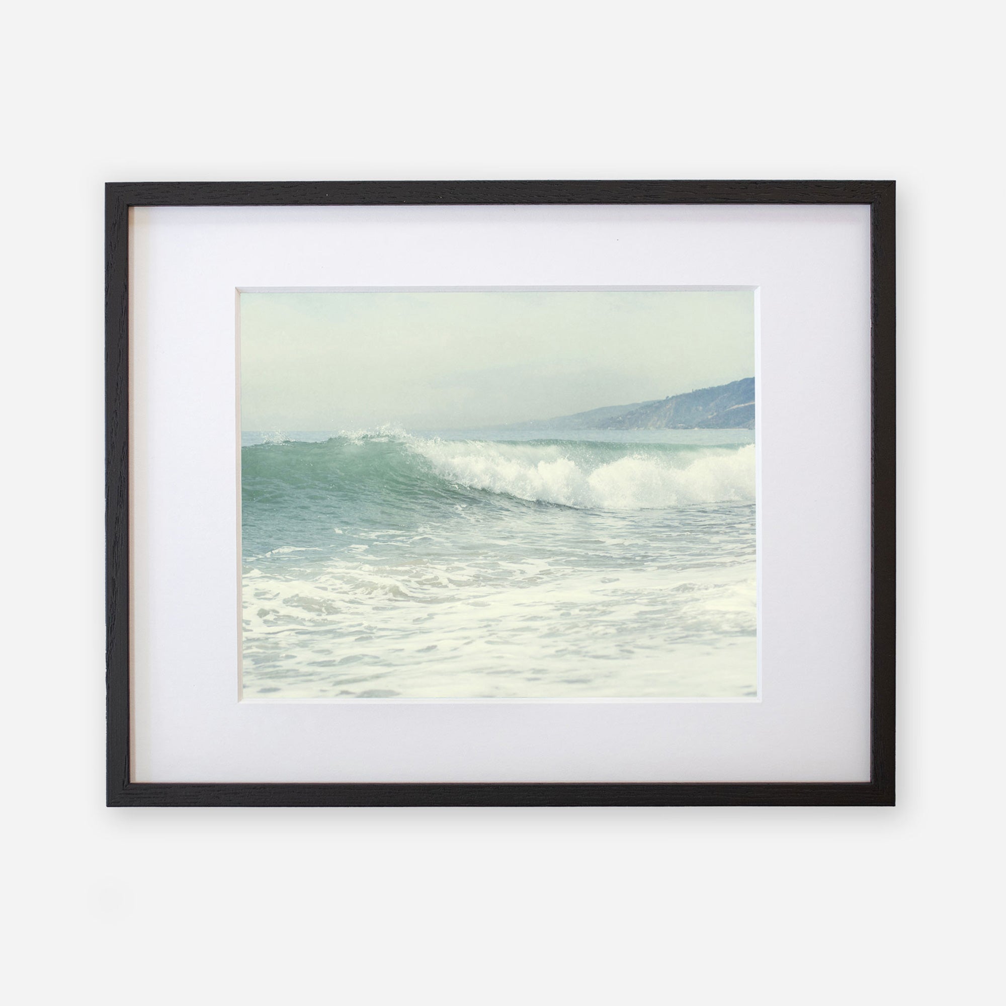 Coastal print of a breaking wave &#39;Breaking Surf&#39; from Offley Green, framed in black with a white mat, capturing a serene oceanic scene.