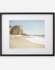 Offley Green's California Malibu Print, 'Point Dume' featuring a serene beach scene with a sandy shore, gentle waves, and a large rock formation at Point Dume under a clear sky.
