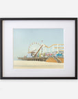A framed Offley Green California Print, 'Santa Monica Pier', featuring a ferris wheel and roller coaster, displayed against a light blue sky.