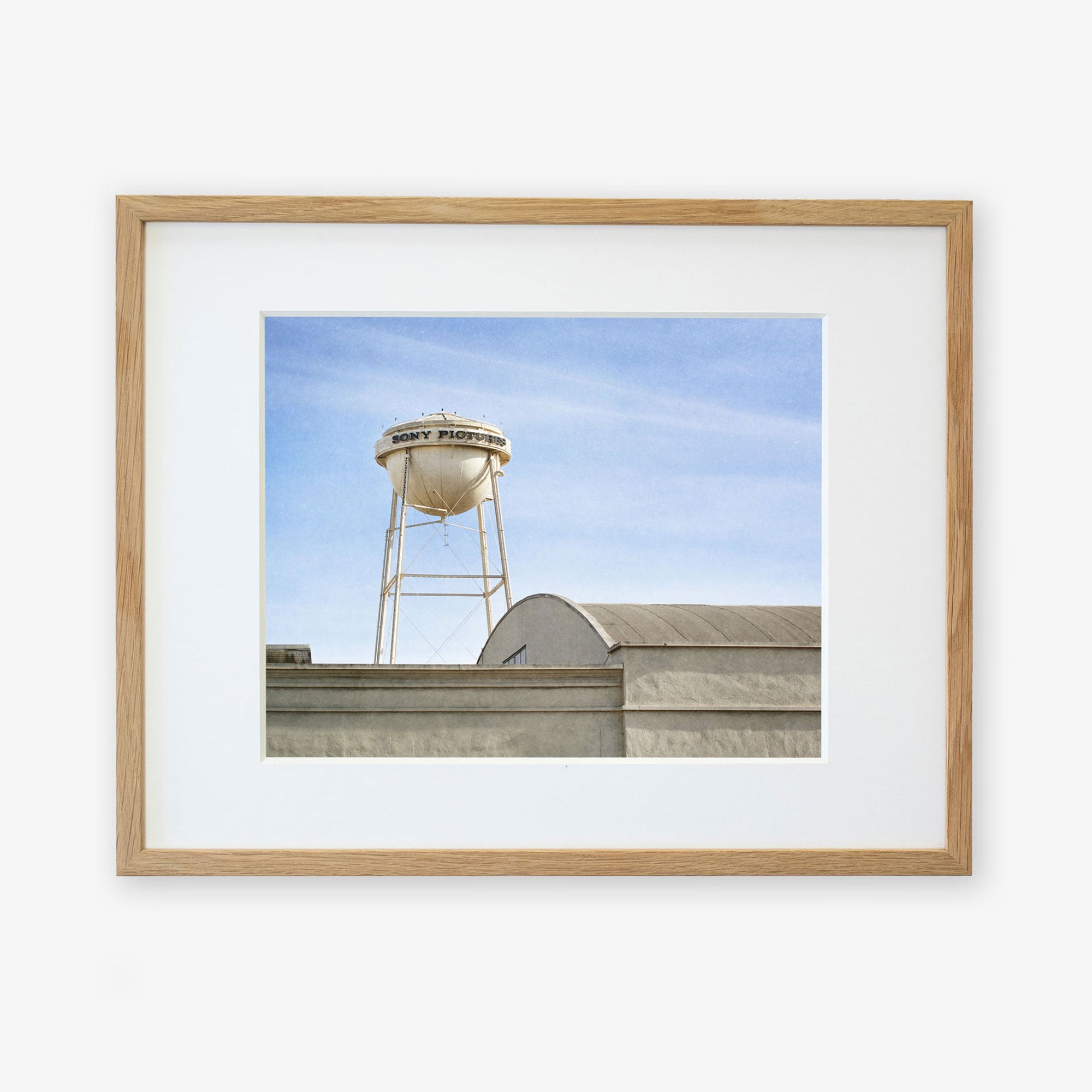 A framed photograph of a water tower labeled &quot;gray power&quot; above Sony Studios, set against a clear sky - Offley Green&#39;s Los Angeles Sony Pictures Studio Print, &#39;Sony Lot&#39;