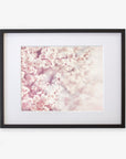 A framed photograph depicting a close-up view of delicate pink cherry blossoms against a softly blurred background, highlighting the floral elegance and pastel hues, Pink Floral Print 'Dreamy Blossom' by Offley Green.