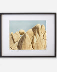 Unframed Joshua Tree print of 'Rock Formations' featuring large, weathered sandstone rocks against a clear blue sky by Offley Green.