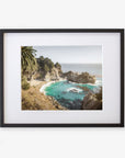 Framed photograph of a Big Sur Coastal Print 'Julia Pffeifer' wall art view with rocky cliffs and turquoise waters, surrounded by green foliage and a sandy beach by Offley Green.