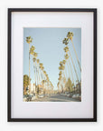 An art print of Los Angeles Palm Tree Lined Street 'Sunset Boulevard Dreams' in a black frame by Offley Green.