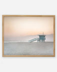 A framed photograph of a Pink Coastal Print, 'Lifeguard Tower' by Offley Green on archival photographic paper.