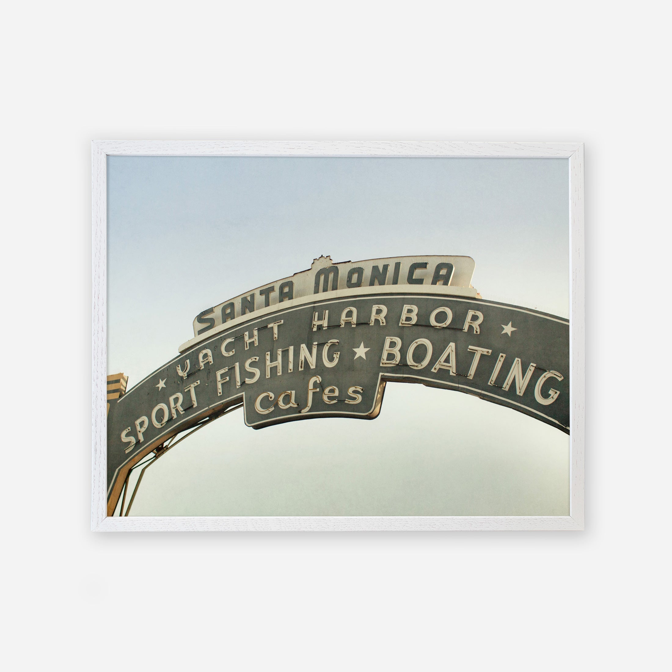 Vintage styled Los Angeles California Print, &#39;Santa Monica Pier Blues&#39; by Offley Green that reads &quot;Santa Monica yacht harbor sport fishing boating cafes&quot; against a clear sky, framed by a white border, captured as an archival photographic print.