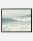 A framed Offley Green Coastal Print of a Breaking Wave 'Breaking Surf', depicting a gentle wave cresting in the ocean with hazy hills visible in the background. The image, printed on archival photographic paper, evokes a serene Southern California beach scene.