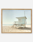 An unframed image of a lifeguard tower on a sandy beach under a clear sky, with the ocean in the background. The tower is painted white with details indicating it is tower number 3.
Product Name: Offley Green's California Summer Beach Art, 'Malibu Lifeguard Tower'