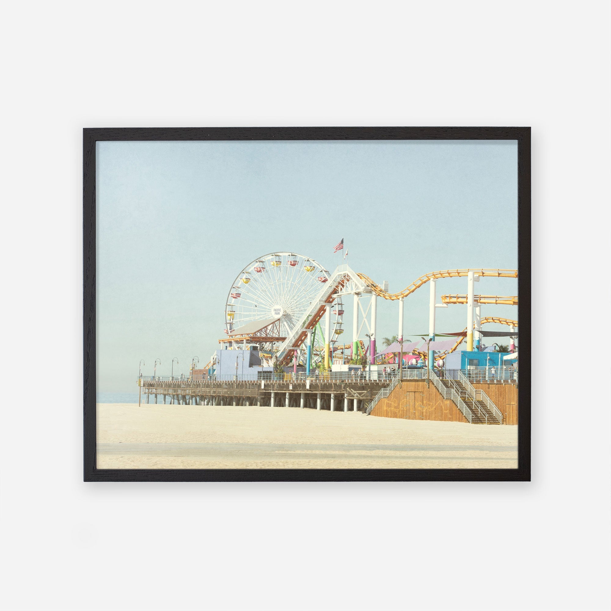 A framed Offley Green California Print, &#39;Santa Monica Pier&#39; on archival photographic paper depicting Santa Monica Pier with a ferris wheel and roller coaster, set against a clear sky.
