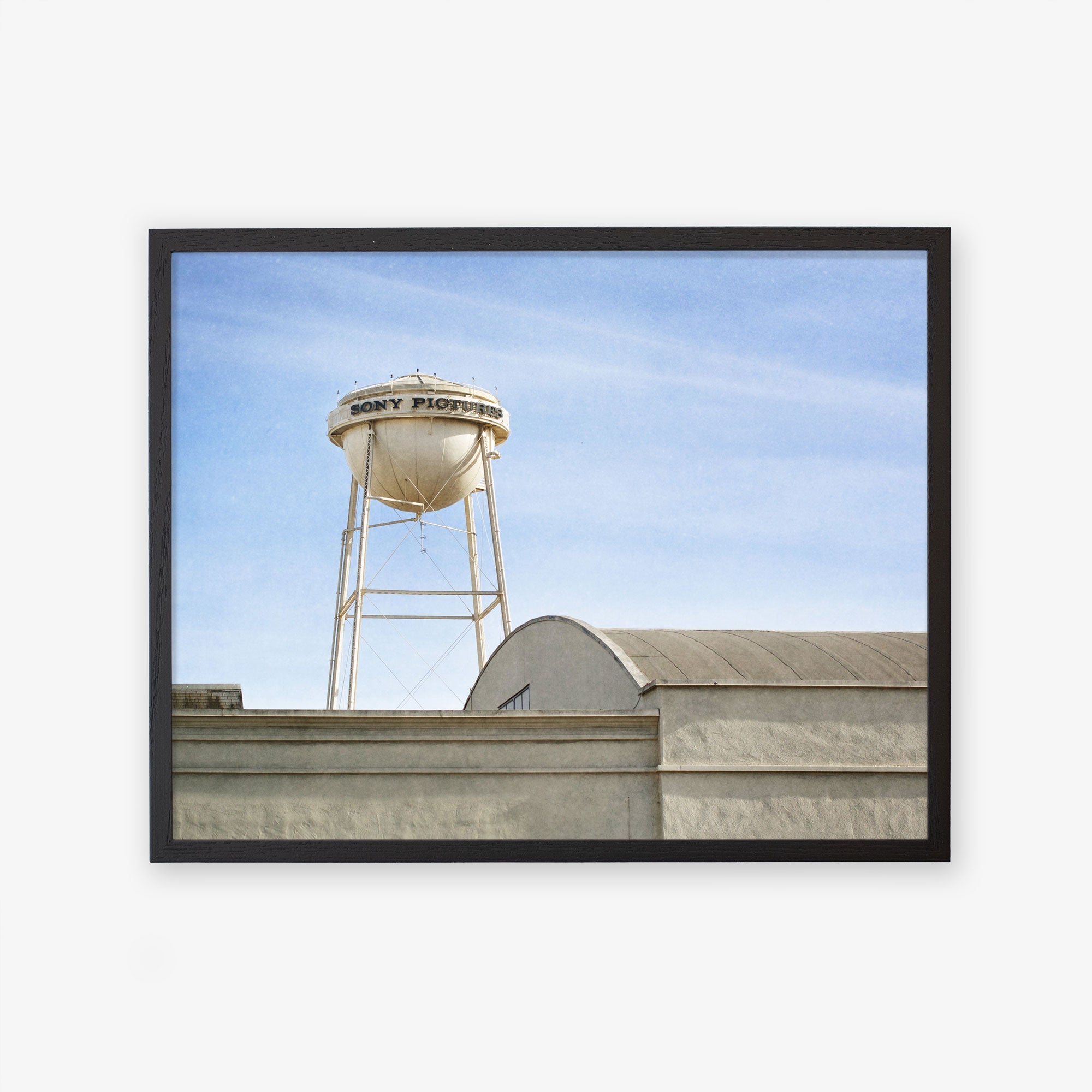 Framed photograph of a classic white water tower labeled &quot;Los Angeles Sony Pictures Studio Print, &#39;Sony Lot&#39;&quot; atop an industrial building against a clear blue sky by Offley Green.