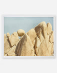 A framed photo of weathered, rounded rock formations in Joshua Tree National Park against a pale blue sky. The rock textures are smooth and intricate, highlighting natural erosion. The frame is simple and white.
Product: Offley Green's Joshua Tree Print, 'Rock Formations'