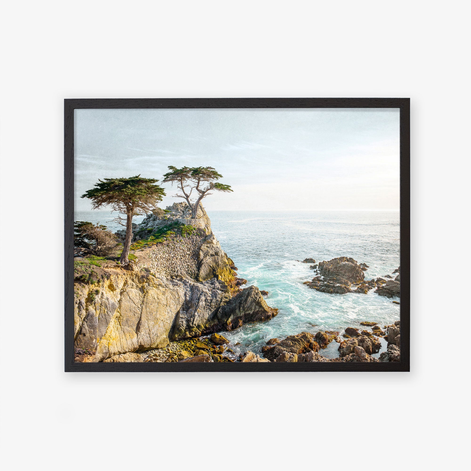 Unframed Offley Green print of a California Coastal landscape at sunset, featuring rugged cliffs with a few trees overlooking a serene sea. The vibrant colors capture the natural beauty and tranquility of the scene.