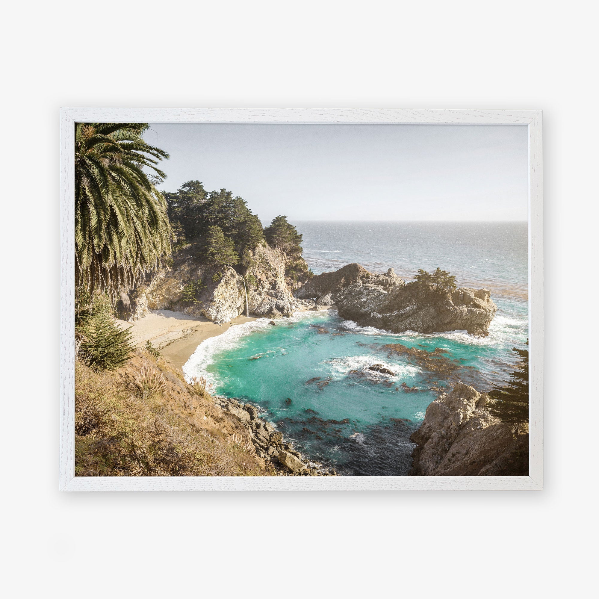 A framed aerial photograph of the Big Sur Coastal Print, &#39;Julia Pffeifer&#39; by Offley Green, on archival photographic paper, depicting a scenic coastal view with turquoise waters, rugged cliffs, and lush greenery under a hazy sky.