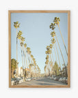 A framed picture of Los Angeles Palm Tree Lined Street 'Sunset Boulevard Dreams', lined with tall palm trees and parked cars, evoking a calm, suburban atmosphere by Offley Green.