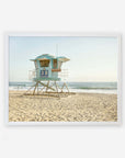 A picturesque Offley Green California Coastal Print, 'Carlsbad Lifeguard Tower' scene featuring lifeguard tower 38 on sandy soil with the ocean in the background, set against a clear sky.