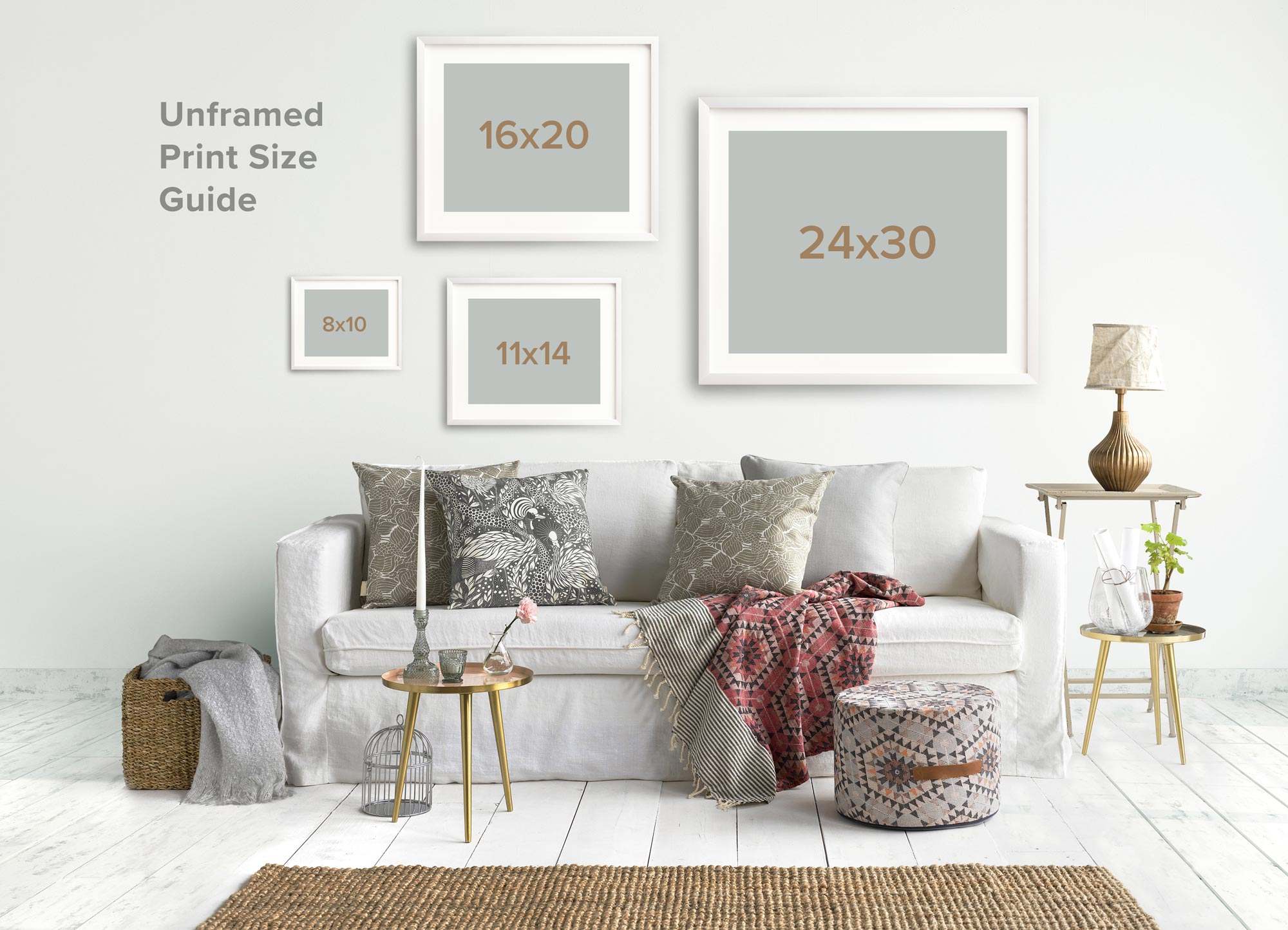 A cozy living room setup featuring a sofa adorned with decorative pillows, a variety of framed wall art sizes on archival photographic paper from Offley Green including the Grey Botanical Print &#39;Dandelion Queen&#39;, side tables with a lamp and plant, and a wicker basket.