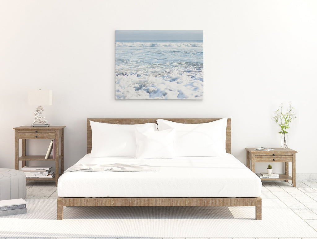 Bedroom canvas wall art featuring a coastal scene of surf breaking on a beach