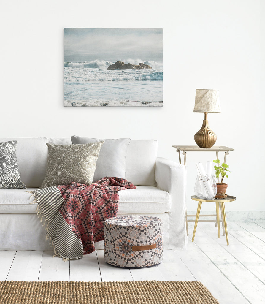 Living room wall art featuring a coastal scene on canvas of waves breaking over rocks